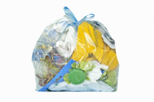 Recycling bins labeled for paper, glass and plastics